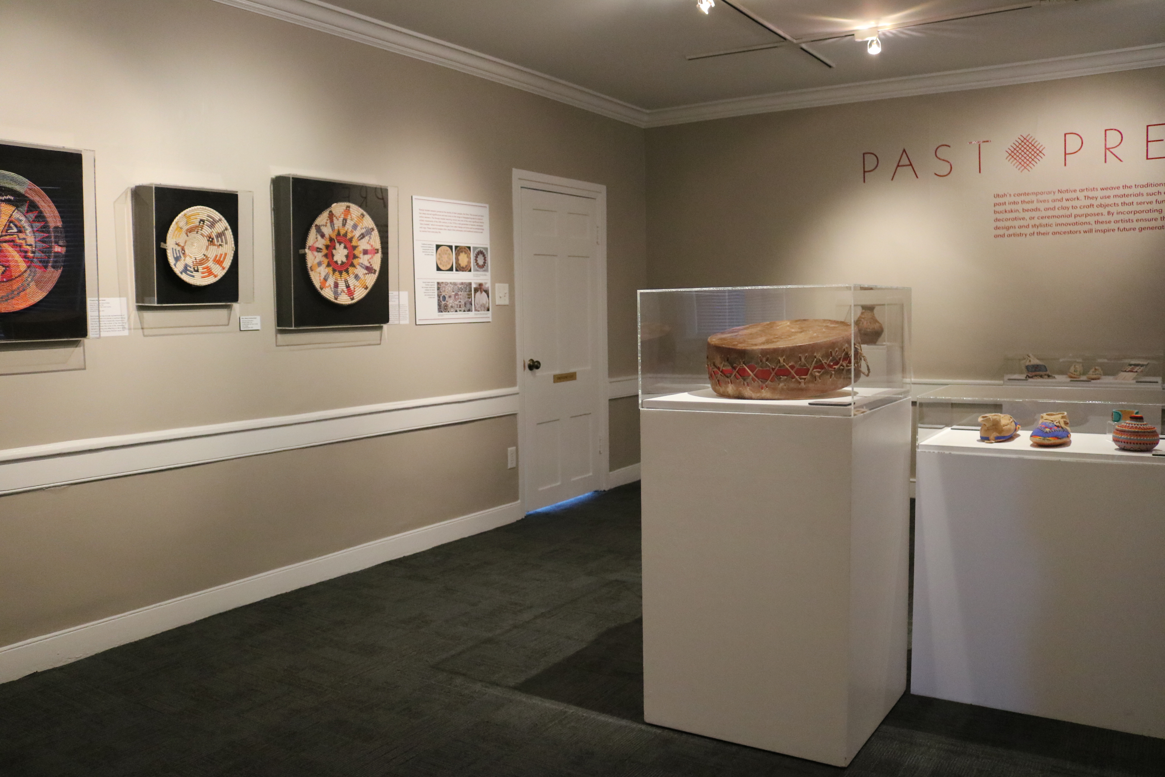 Artifacts in glass cases in a gallery.