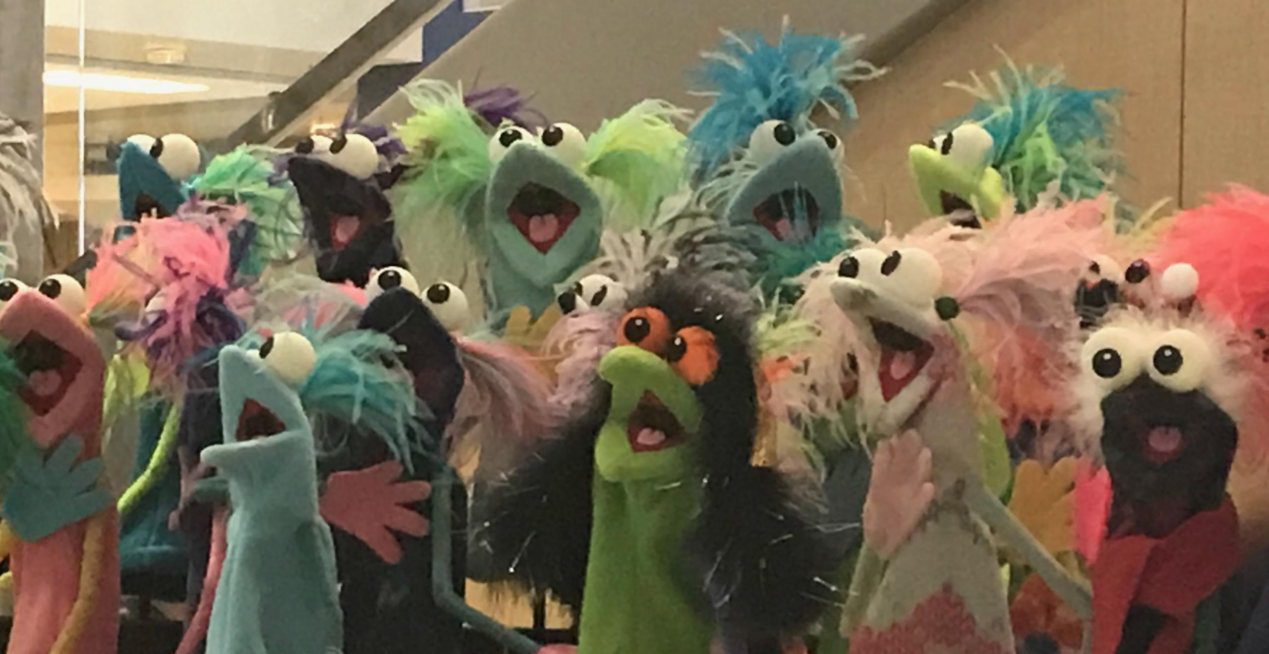 A group of brightly colored puppets.