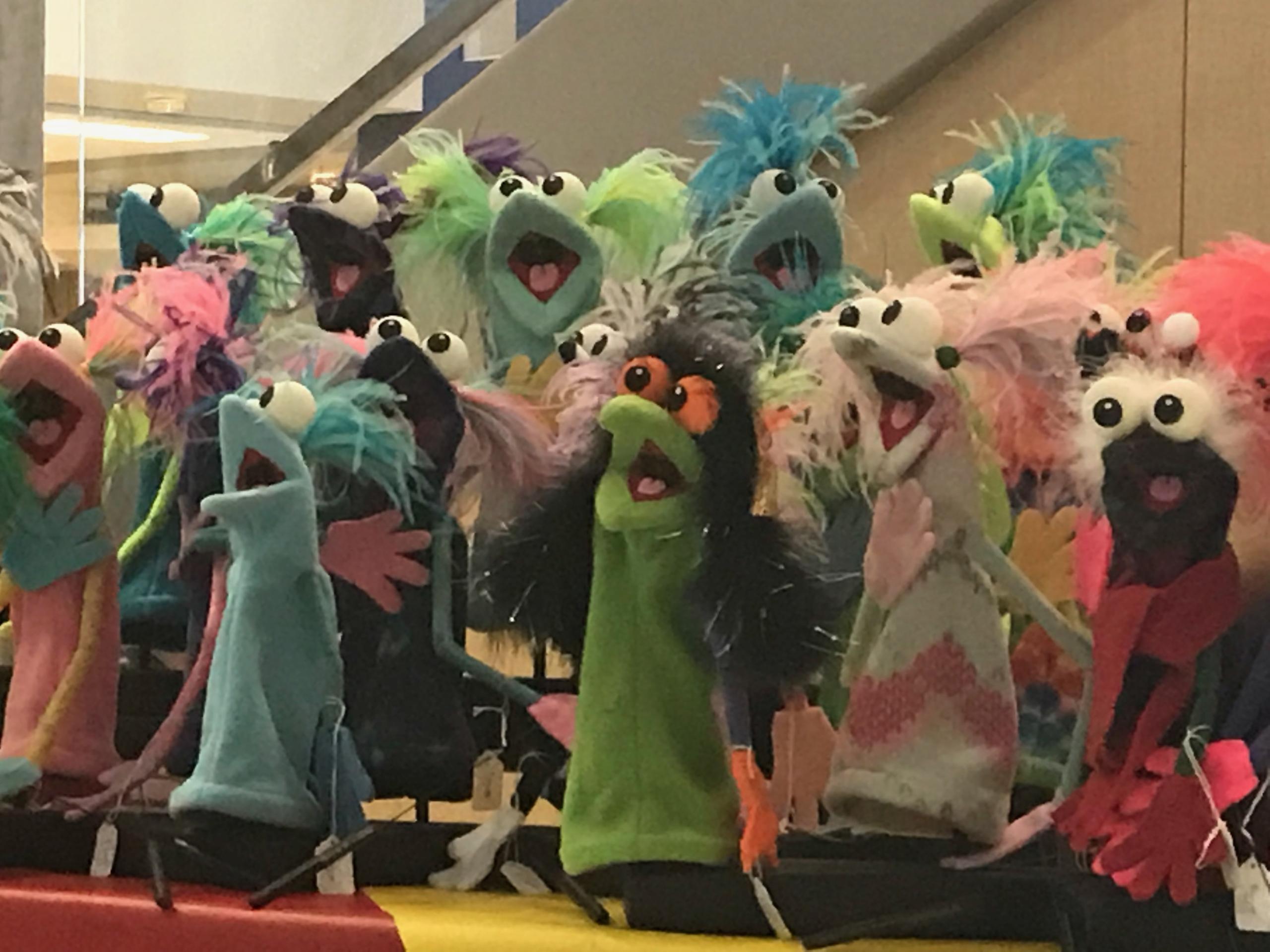 A group of brightly colored puppets.