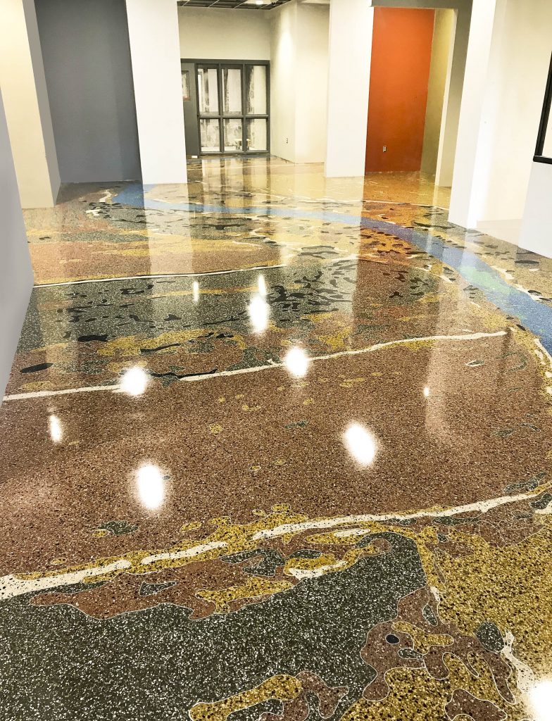 A terrazzo floor in shades of brown, gold, and black. 