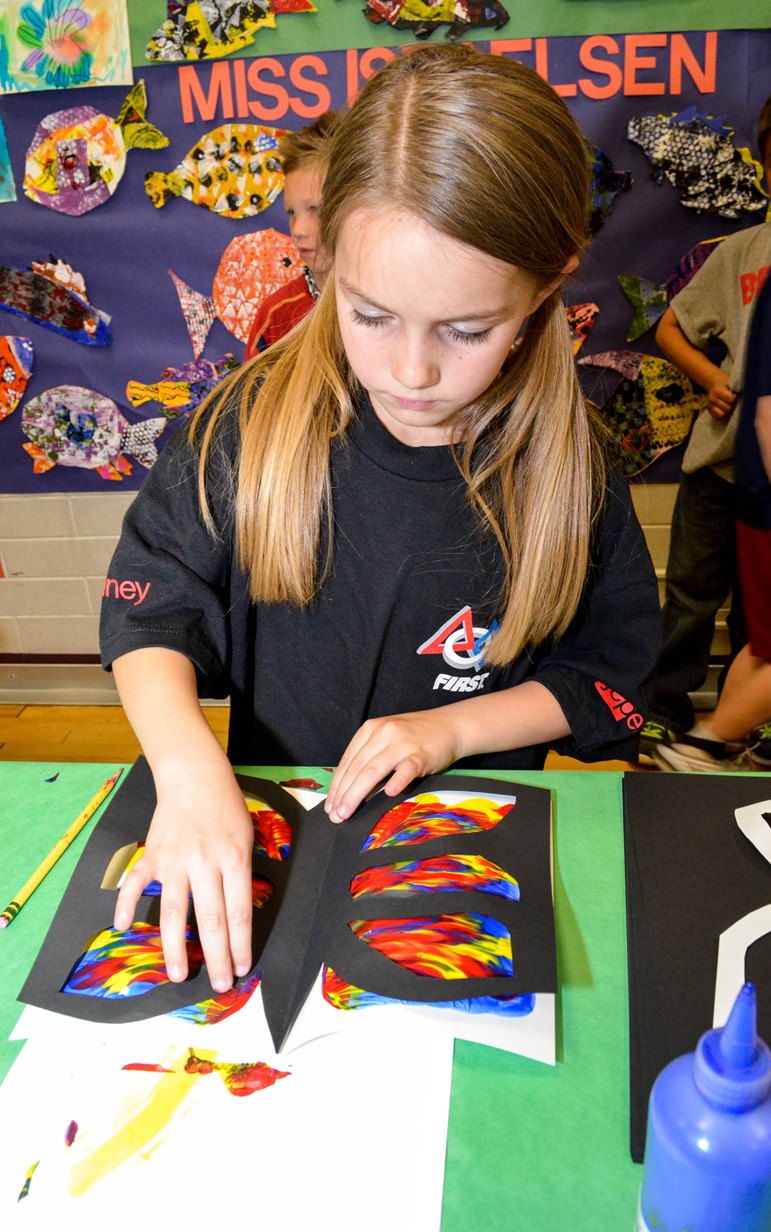 An image of a young girl doing an art project.