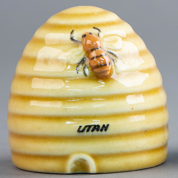 A photo of a ceramic beehive sculpture with a bee on it and the word, Utah."