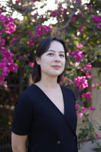 A woman with dark hair in a black shirt.