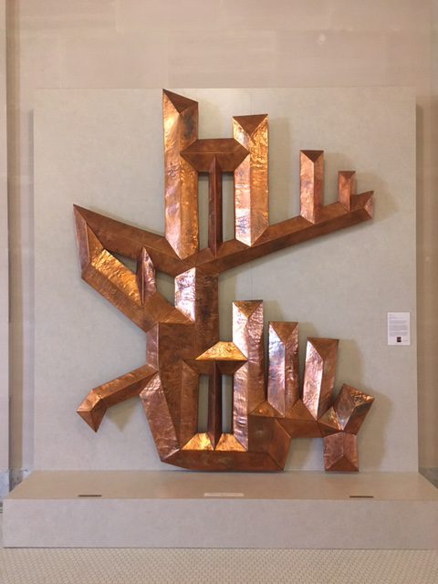 An abstract copper sculpture.