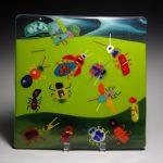 Glass artwork featuring bugs.