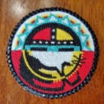 A circular piece of intricate Native American beadwork