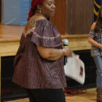 Teaching artist Joan Effiong working with students