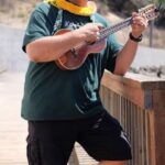 A portrait of Teaching Artist Kumu Gaui with his ukulele