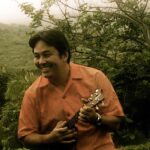 Teaching artist Micah Hirokawa playing a ukulele