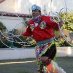 A portrait of teaching artist Patrick Willie performing a hoop dance