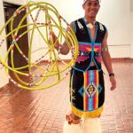 A portrait of teaching artist Poamo Aliifua Gatewood with a ball of dancing hoops