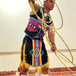 Teaching artist Poamo Aliifua Gatewood performing a hoop dance