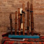 a collection of wooden flutes on display