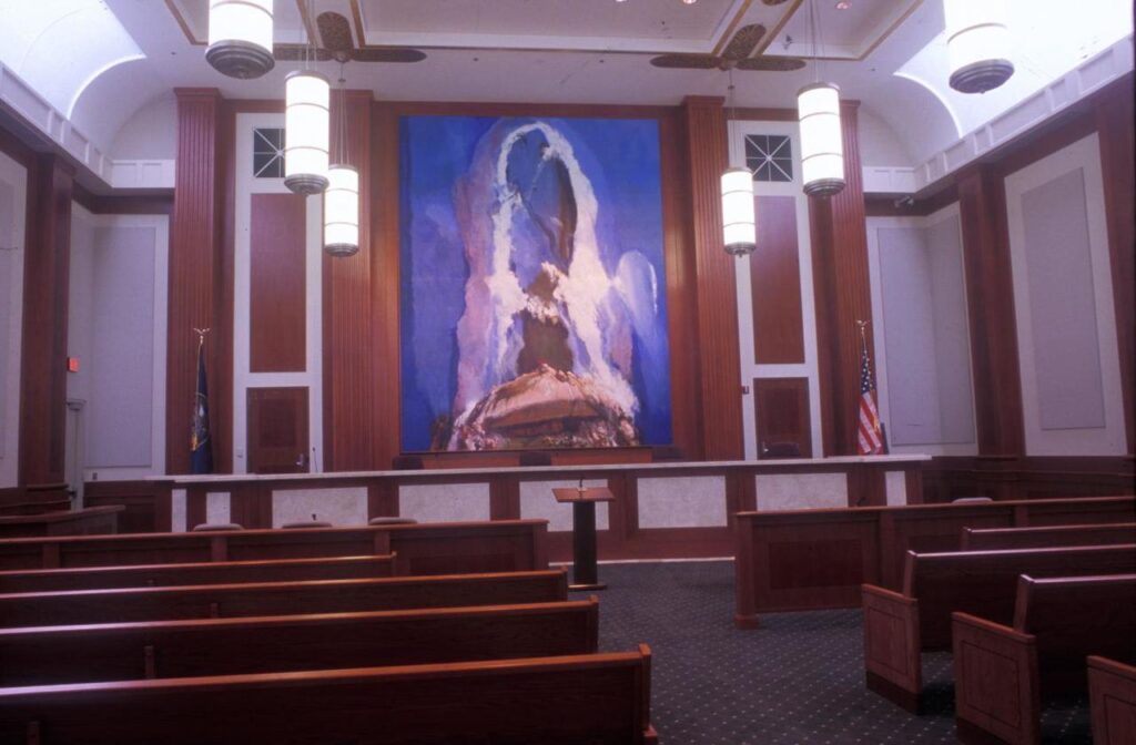 An abstract paining of a red rock landscape hangs in a courtroom.