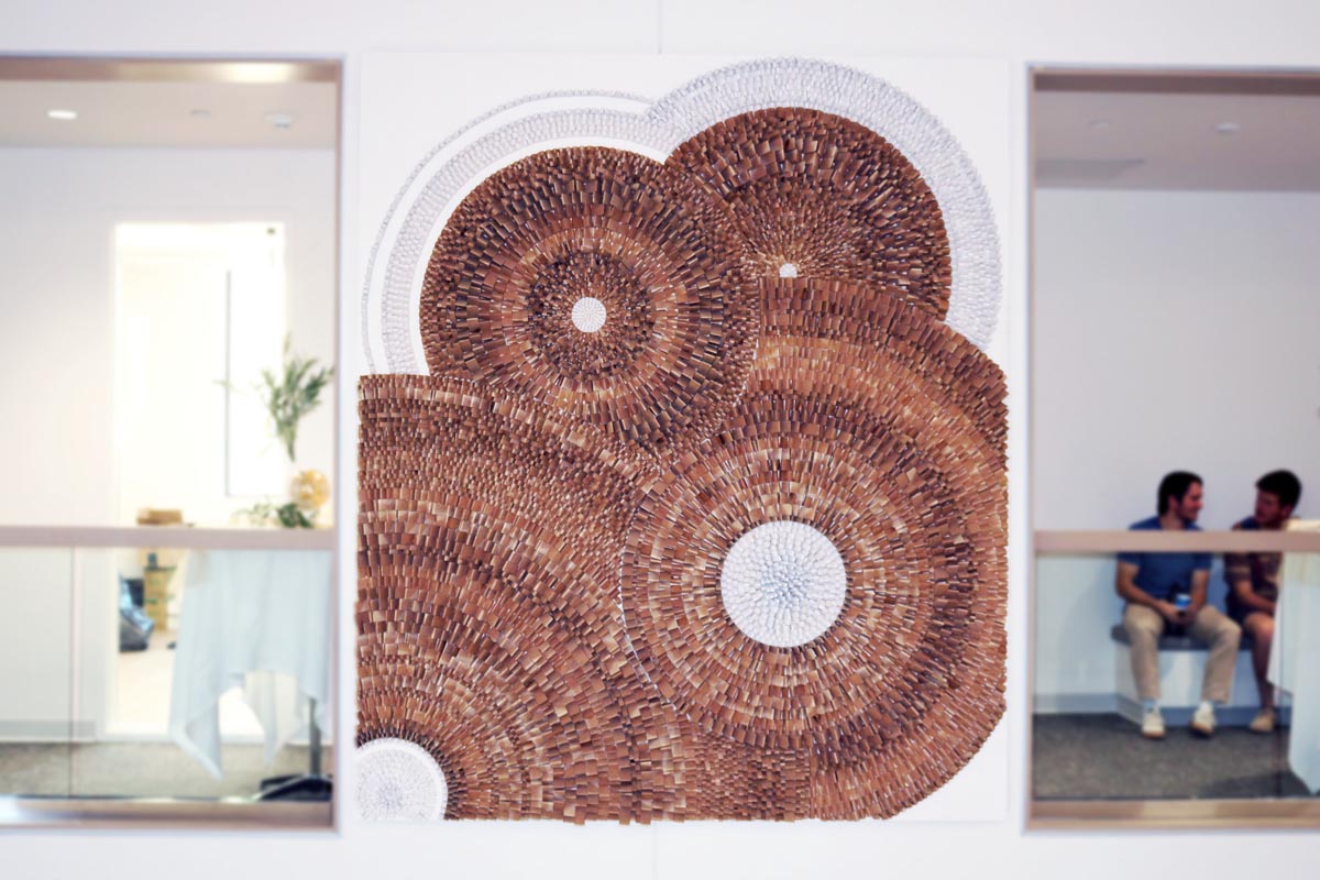 An intricate wood artwork on the wall between two openings.