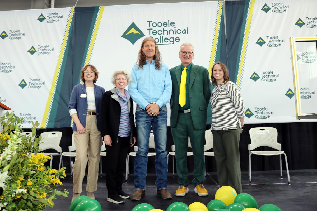 A group posing on stage at the Tooele Technical College.