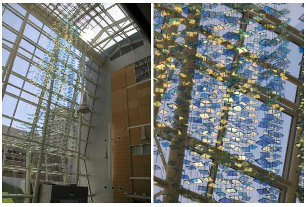 A duo of photos showcasing public artwork in a building made of strands of falling stained glass squares.
