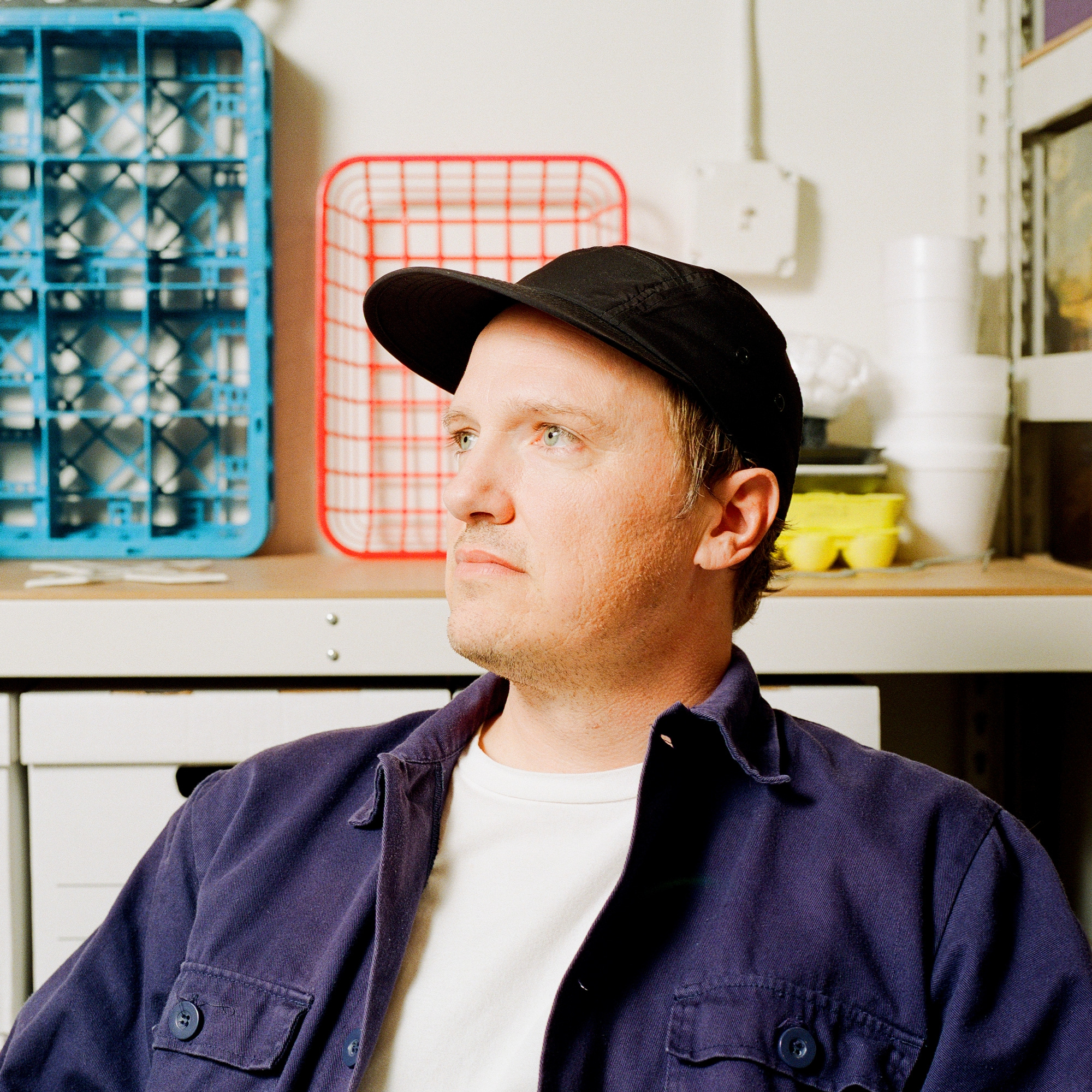 A man in a black ball cap and a purple shirt.