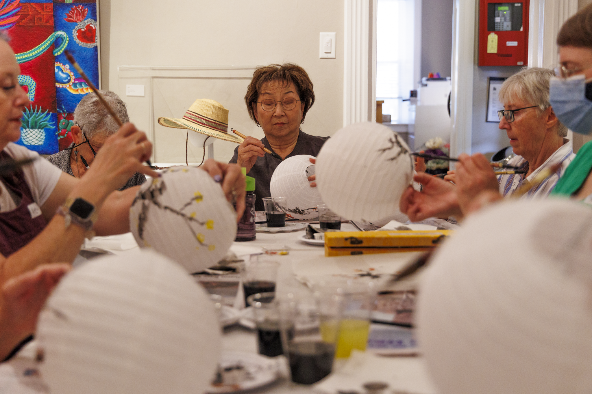 Artist Joon Bae working with workshop participants.